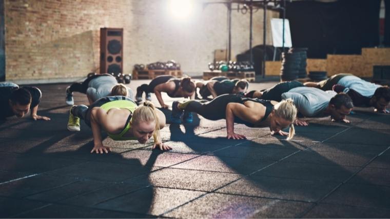 A group of people working out together, performing push-ups