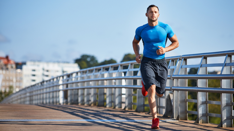 Athletic man jogging outdoors