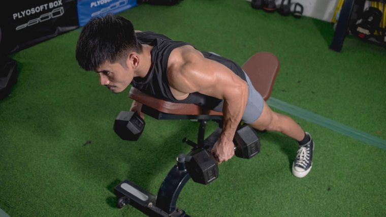 Man performing two-dumbbell row on bench