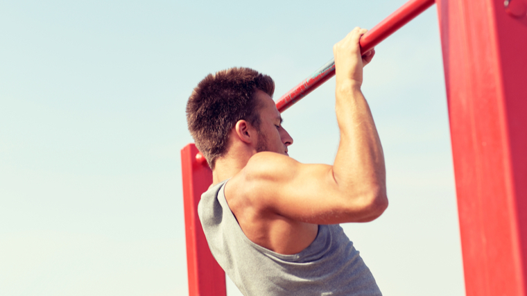 Man performing pull-ups outside