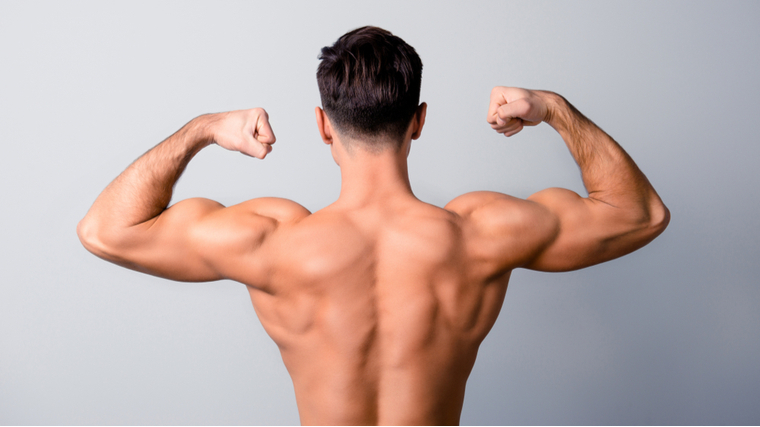 Bodybuilder flexing shoulder and back muscles